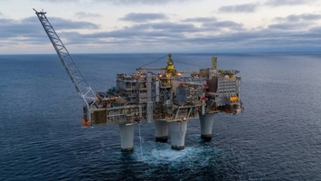 Aerial view of a fixed offshore oil platform in the North Sea at dusk